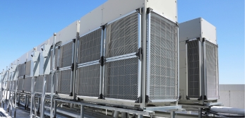 Variable refrigerant flow system on a rooftop with blue sky in the background.